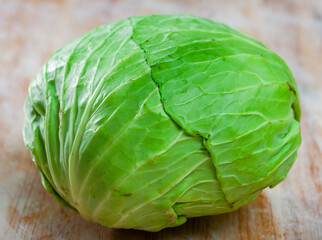 Fototapeta premium Vegetable ingredients for cooking, organic cabbage on wooden table