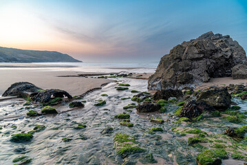 rocks on the beach in Wales during sunrise  © Grzegorz