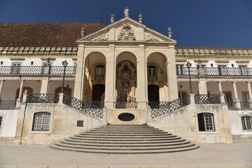 Frontal view of the elegant Baroque white limestone central portico and staircase of Via Latina ensemble of Coimbra University, relief of King José I in the center, Coimbra, Portugal