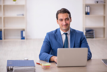 Young male employee working in the office