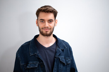 young man standing on grey background