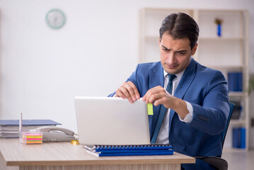 Young male employee working in the office