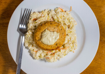 salmon burger top with tarter sauce on  dixe cole slaw