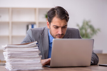 Young male employee working in the office