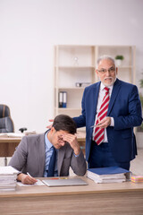 Two male colleagues sitting in the office