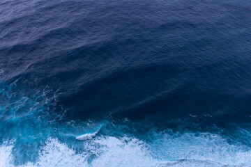 ocean surf waves at sunset view from above