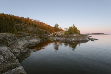 Rocky island on a lake in northern Europe in evening