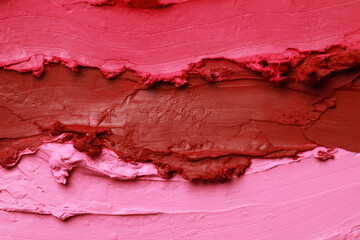Texture of beautiful lipsticks as background, top view