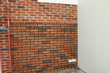 Decorative bricks with tile leveling system on white wall