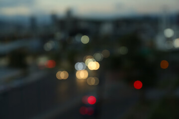 Blurred view of cityscape in evening. Bokeh effect