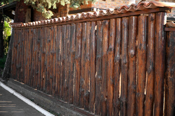 Brown wooden fence outdoors on sunny day