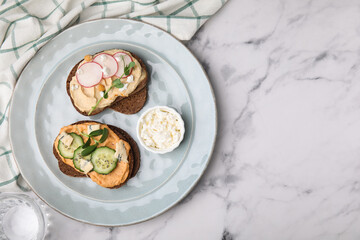 Delicious sandwiches with hummus and different ingredients on white marble table, flat lay. Space for text
