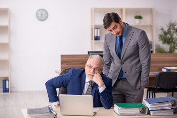 Two male colleagues working in the office