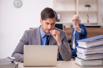 Fototapeta premium Two male colleagues working in the office