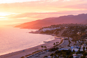 Coastline landscape over Malibu, California during a colorful sunset showing the beach and ocean...