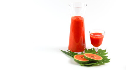 Papaya smoothie in glass jar and glasses on white background diet vegetarian healthy and freshness drink concept soft and selective focus