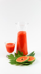 Papaya smoothie in glass jar and glasses on white background diet vegetarian healthy and freshness drink concept soft and selective focus