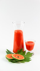 Papaya smoothie in glass jar and glasses on white background diet vegetarian healthy and freshness drink concept soft and selective focus