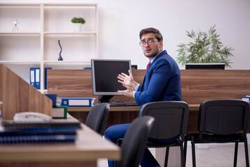 Young male employee working in the office