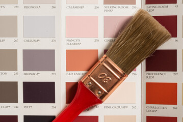 Den Helder, Netherlands. July 2022. paint brush on a colored sample card.