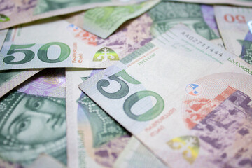 Background photo with green cash paper notes of Georgia. 50 GEL. Georgian lari. Money to payment for purchases, pay off a loan. Travel and tourism concept. Currency exchange. Queen Tamara. banknote