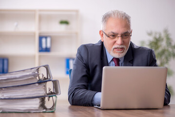 Old male boss employee working in the office