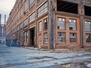 Broken windows on an abandoned brick building at the Bethlehem Steel site in Bethlehem Pennsylvania - 551421913