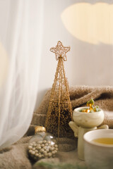 Christmas composition. Hot tea, candles, Christmas golden balls and decorations. Christmas holiday mood. Winter concept.