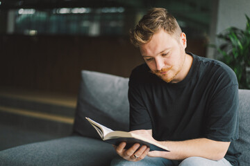 Christian man holds holy bible in hands. Reading the Holy Bible in a home. Concept for faith,...
