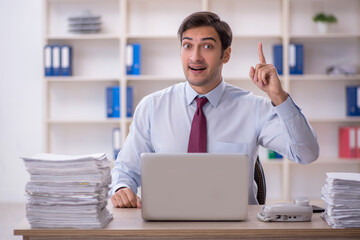 Young male employee and too much work in the office