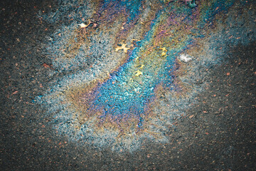 Oil slick on the asphalt road background