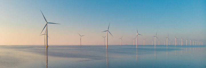 Windmill turbines at sea with a blue sky, Wind mill Turbine in ocean in the Netherlands