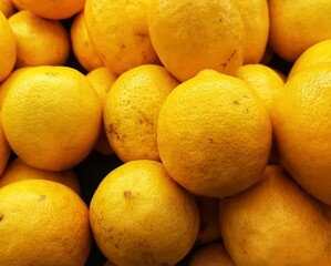 pile of fresh Lemons. Yellow lemons are sold in traditional markets.