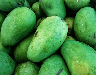 pile of fresh mangoes for sale in the market. healthy fruit full of vitamins