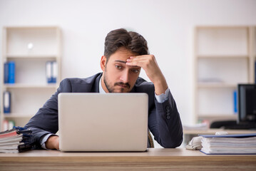 Young male employee working in the office