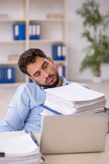 Young male employee working in the office