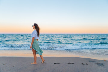 Woman on the beach enjoying summer holidays