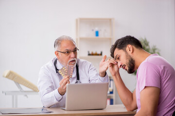 Young male patient visiting old male doctor