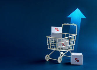 Inflation, increase sales, rising up price, business marketing concepts.  Red percentage icon on parcel boxes in white shopping cart trolley with rising arrows on blue background with copy space. © tete_escape