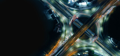 Aerial view of car traffic transportation above circle roundabout road in Asian city. Drone aerial view fly in circle, high angle. Public transport or commuter city life concept of economic energy	
