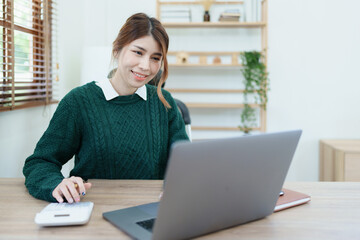 financial, Planning, Marketing and Accounting, portrait of Asian employee checking financial statements using documents and calculators at work