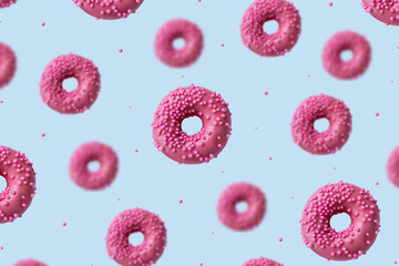 A pink soaring doughnut on a pink background. the doughnut flies. minimalistic creative design. High quality photo