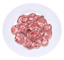 slices of Spanish Fuet thin dried salami sausage on white ceramic plate