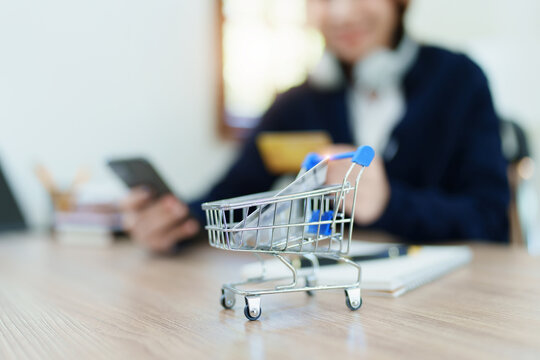 Online Shopping and Internet Payments, Asian man are using their credit card and mobile phone to shop online or conduct errands in the digital world.