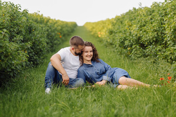 Fototapeta premium young couple sitting on grass and relaxing