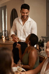 Young man, black woman and date with glass champagne or dinner party in restaurant. New Years,...