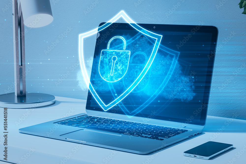 Poster Close up of laptop, cellphone and lamp with glowing shield hologram on screen. Blurry desktop background. Secure, protection, safety and web security concept. 3D Rendering.