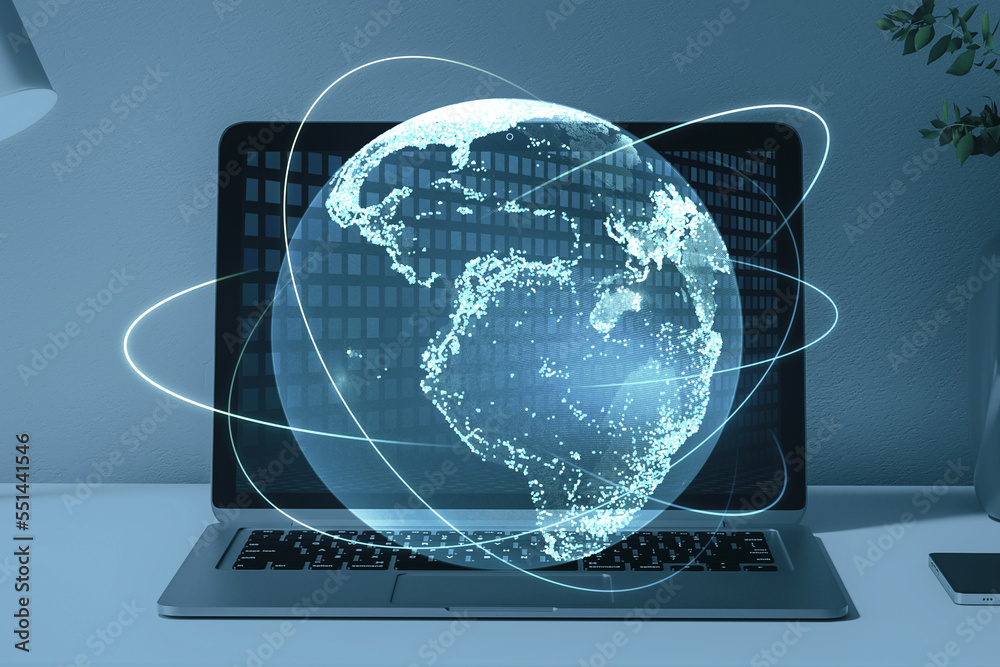 Poster close up of laptop computer on desktop with creative glowing globe hologram on blurry background. te