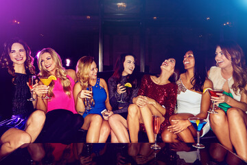 Cocktail, happy or friends at a vip party laughing at funny joke or drinking alcohol at social...