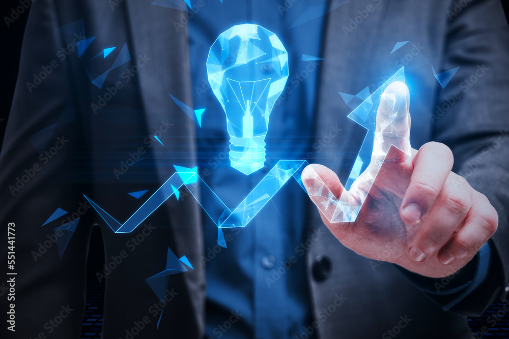 Poster close up of businessman hand holding at abstract glowing polygonal light bulb and arrow on dark back